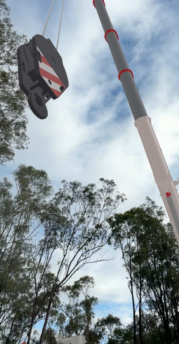VisualQuip AR screenshot showing a crane boom and hook block from below against trees and daylight sky